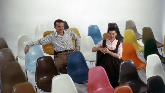 Portrait of Charles and Ray Eames sitting on the Eames Shell Chair
